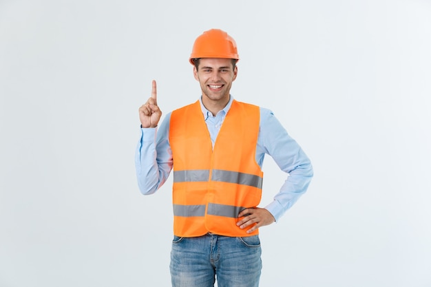 Portrait of happy young foreman with orange vest isolated over white background.