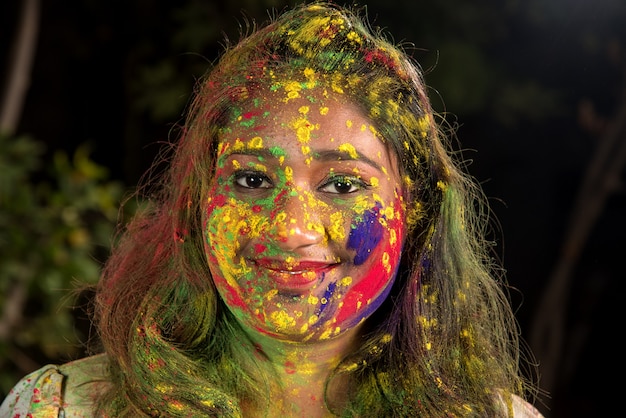 Portrait of a happy young girl on the festival of colors Holi. Girl posing and celebrating the festival of colors.