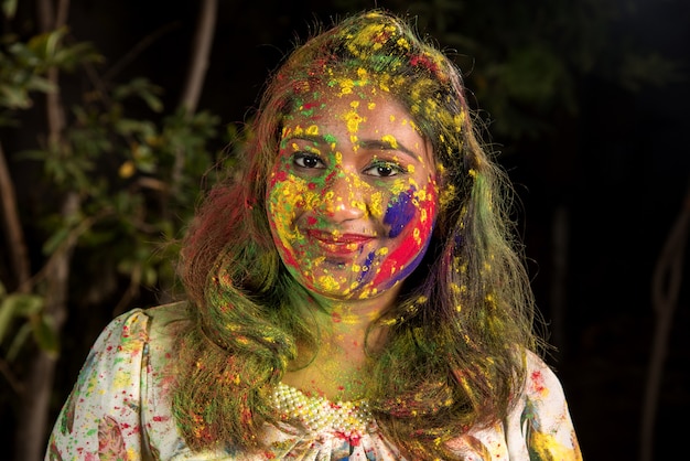 Portrait of a happy young girl on the festival of colors Holi