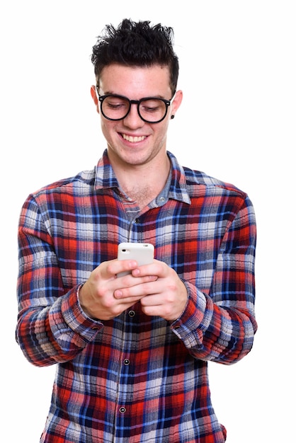 Portrait of happy young handsome hipster man using phone