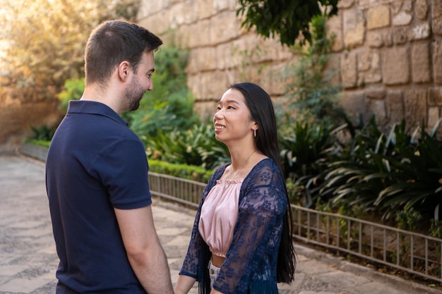 Portrait of a happy young interracial couple in love. Chinese woman and white and brown man. Concept of love.