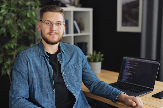 Portrait of happy young man coder