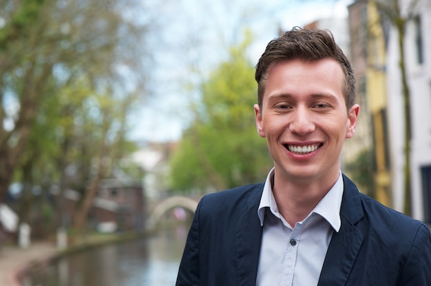 Portrait of a happy young man outdoors