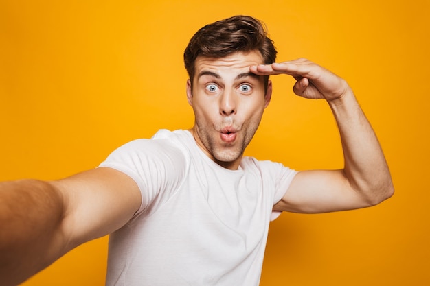 Portrait of a happy young man taking a selfie