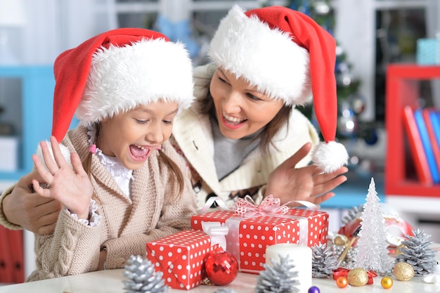 Portrait of happy young mother and daughter preparing for Christmas