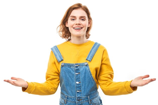 Portrait of happy young redhead woman spreading hands with joy and inspiration Hands wide open isolated on white studio background