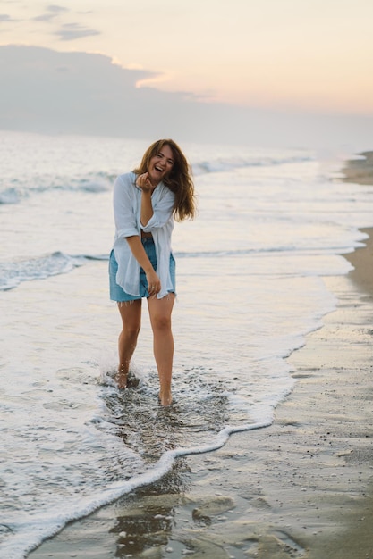 Portrait of a happy young woman on a background of beautiful sea