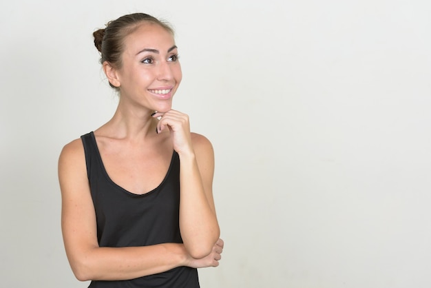 Portrait of happy young woman with brown hair thinking