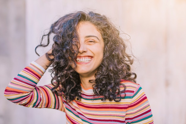 Portrait of a happy young woman with curly hair