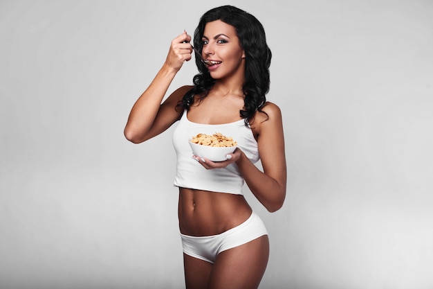 Portrait of healthy fitness woman eating quick breakfast