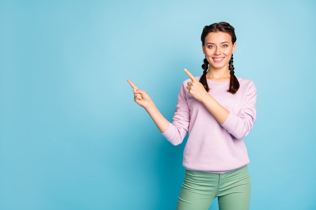 Portrait of her she nice attractive lovely charming cheerful cheery girl showing copy space isolated over bright vivid shine vibrant blue green teal turquoise color