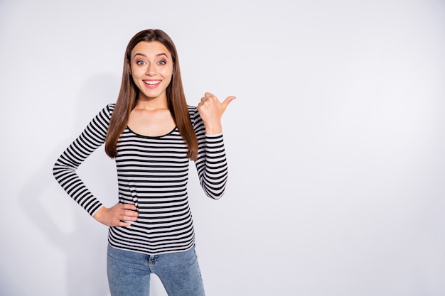 Portrait of her she nice attractive shine charming lovely pretty cheerful cheery funny girlish straight-haired girl showing copy space ad advert isolated over white light wall