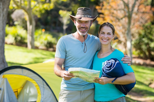 Portrait of hiker couple holding map