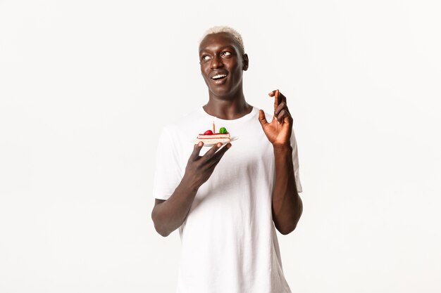 Portrait of hopeful attractive Black guy celebrating birthday