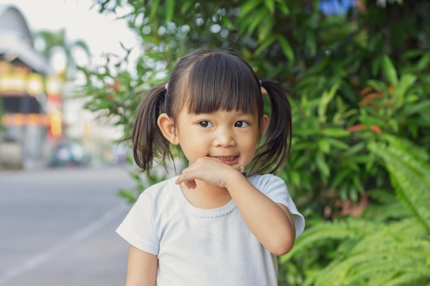 Portrait image of 45 years old baby toddler Face of smiling Asian girl in head shot Happy kid playing at the park playground