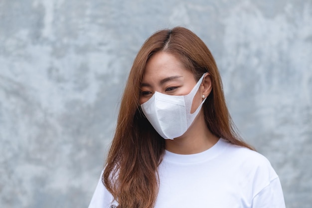 Portrait image of an asian woman wearing protective face mask for Healthcare and Covid19 concept