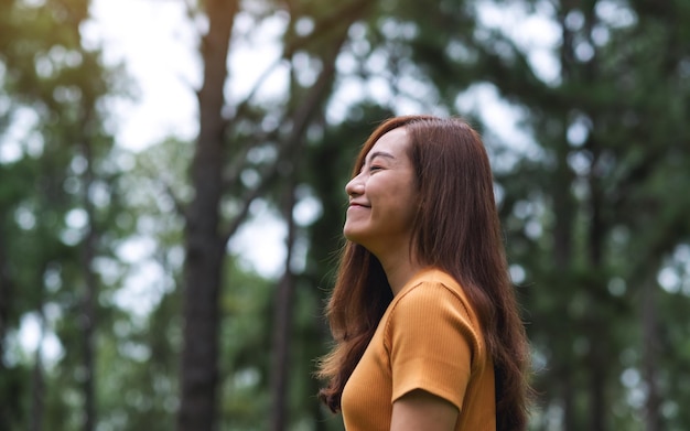 Portrait image of a beautiful young asian woman standing in the park