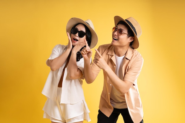 Portrait image of couple posing on yellow background summer travel