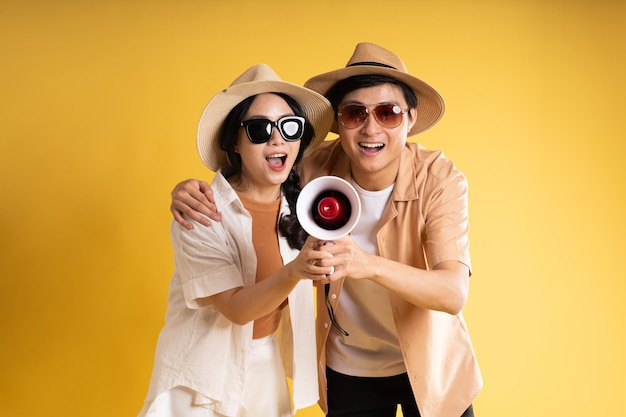 Portrait image of couple posing on yellow background summer travel