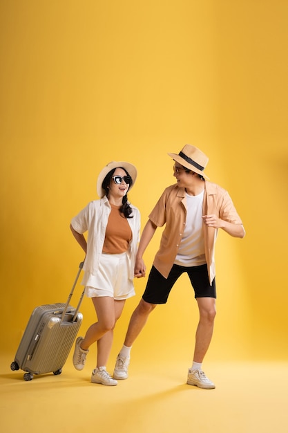 Portrait image of couple posing on yellow background summer travel