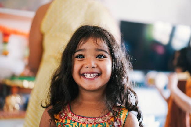 Portrait of indian female kid wearing sari dress - Southern asian child having fun smiling - Childhood, different cultures and lifestyle concept - Focus on nose