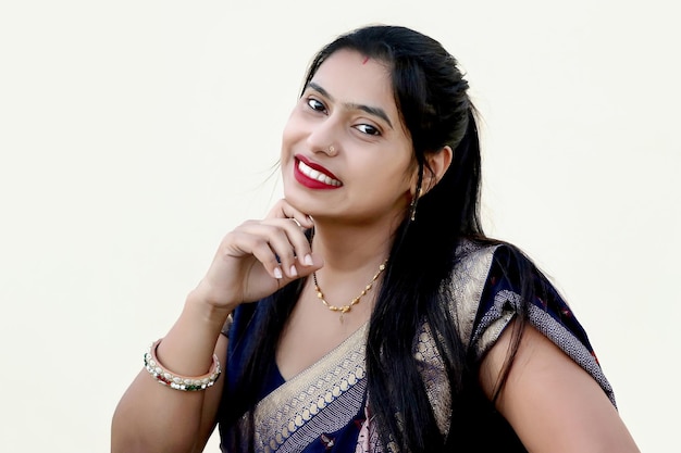 Portrait of an Indian happy woman wearing traditional dress sari in white background