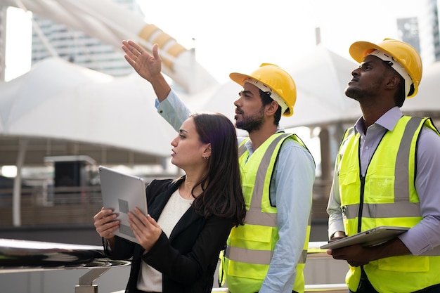 Portrait of an industrial man and woman engineer with tablet in a factory, talking.