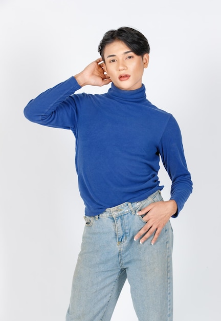 Portrait isolated cutout studio closeup shot of Asian young sexy slim fashionable LGBTQ gay male model in turtleneck longsleeve shirt denim jeans standing posing look at camera on white background