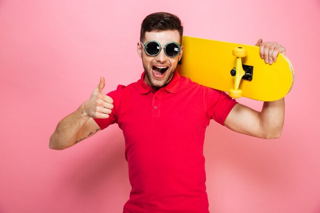 Portrait of a joyful young man in sunglasses