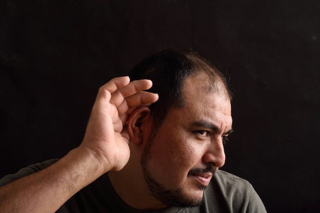 Portrait of a latin man with noise on black 