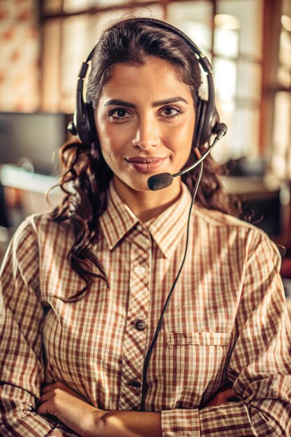 Photo portrait of a latin telephone operator standing with headset on