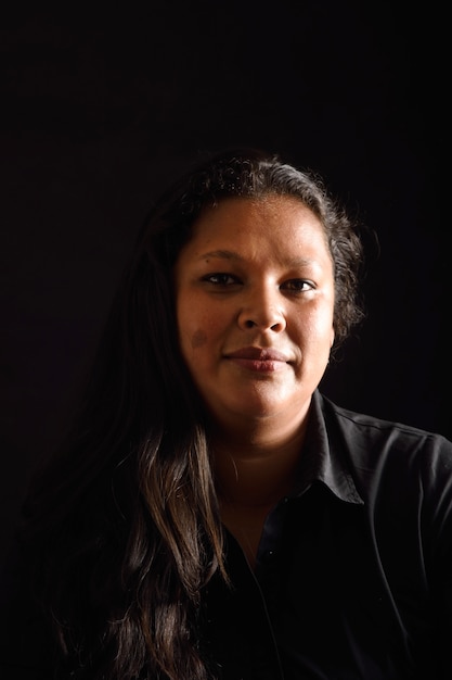 Portrait of a latin woman on black background