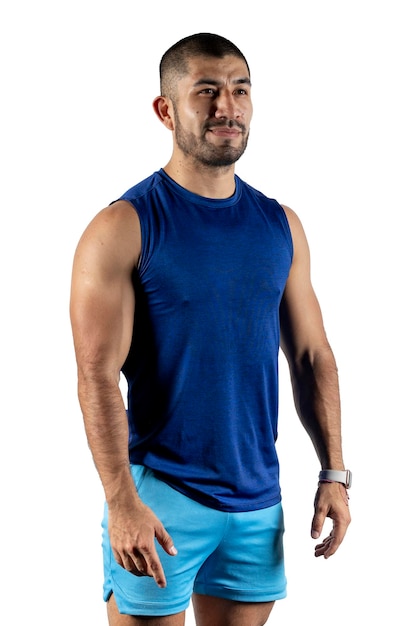 Portrait of a Latino man in blue sportswear standing looking straight ahead against white background