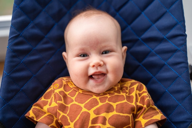 Portrait of a laughing cute baby. newborn baby smiles at the camera