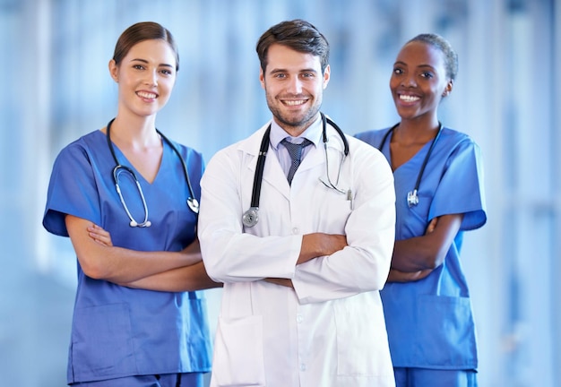 Portrait leader and happy medical team in hospital for healthcare service in clinic Confidence doctor and smile of diverse group of nurses in collaboration cooperation or arms crossed together