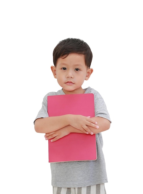 Portrait of little Asian baby boy age about 3 years old hugging a book on white isolated background with clipping path Education concept