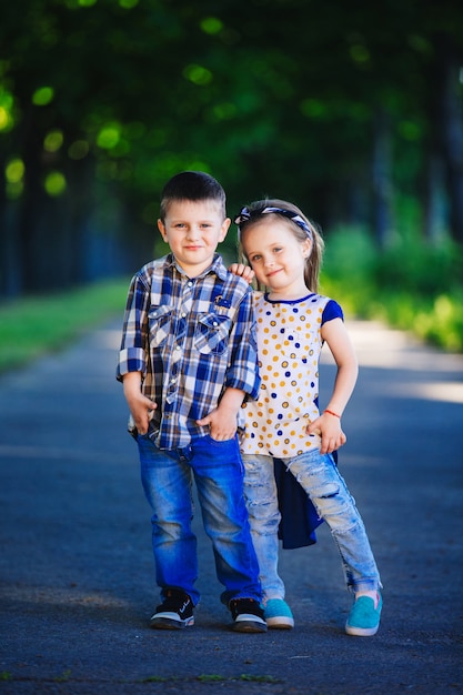 Portrait of little boy and girl in a park