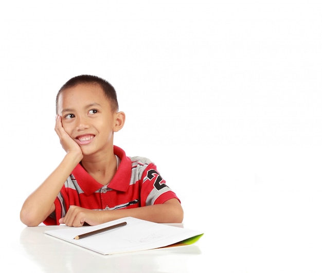 Portrait of little boy thinking and look up to copy space