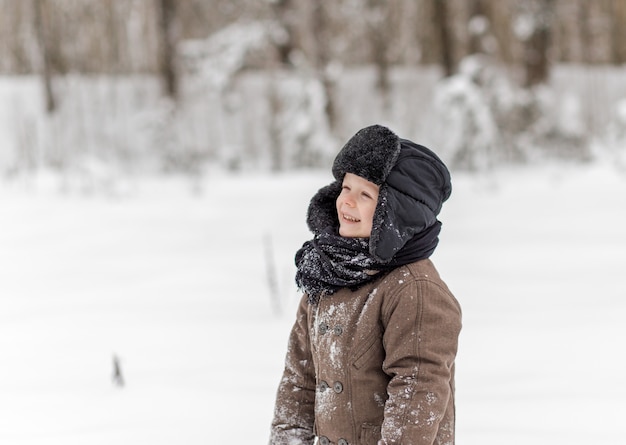 portrait of a little boy in a winter forest