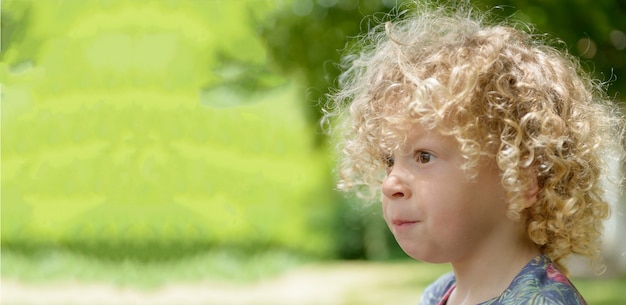 Portrait of a little boy with blond curly hair