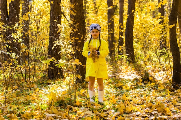 Portrait of little girl in autumn forest