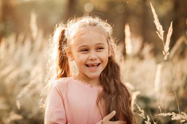 Portrait of a little girl on the background of the autumn park.