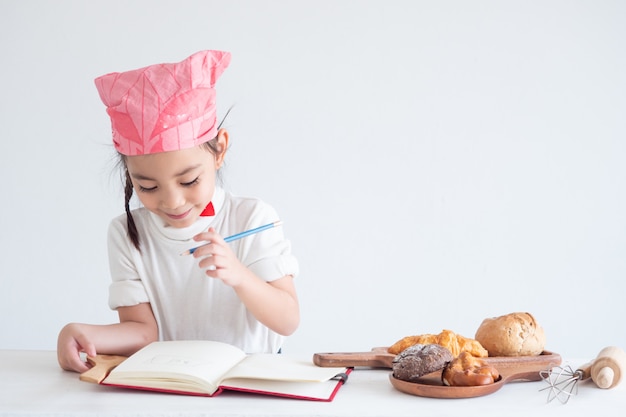 Portrait of a little girl cooking