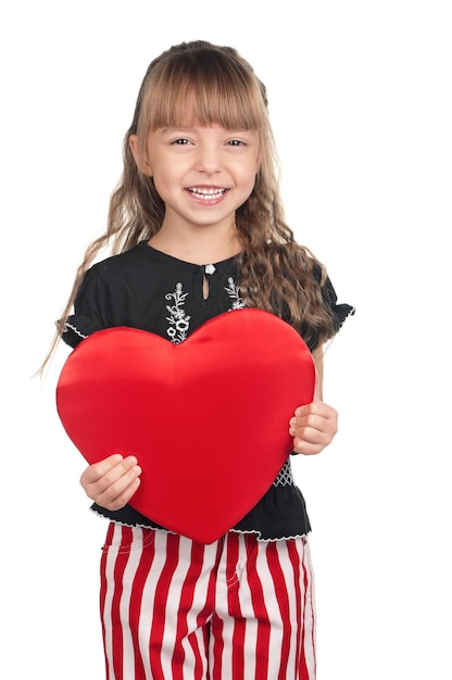 Portrait of little girl holding red heart over white background