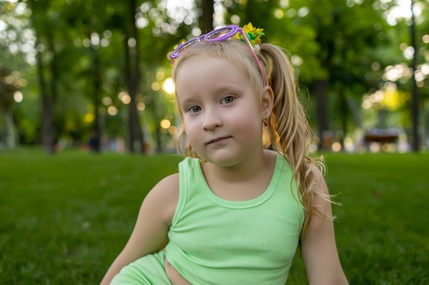 Portrait of a little girl model who poses for the camera while in the park