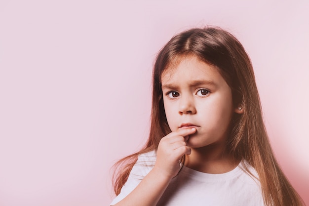 portrait of a little girl on a pink background