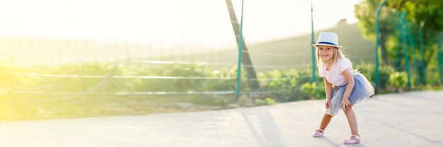 Portrait of little girl with blonde hair outdoor