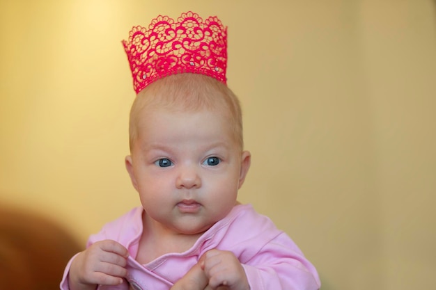 Portrait of a little threemonthold girl in a crown Child princess