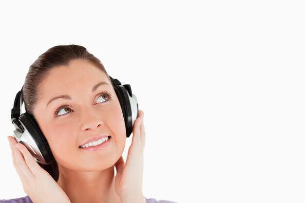 Portrait of a lovely woman posing with headphones while standing