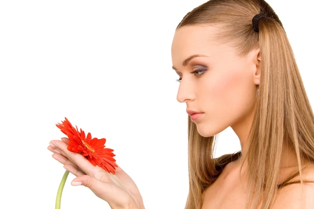 Portrait of lovely woman with red flower